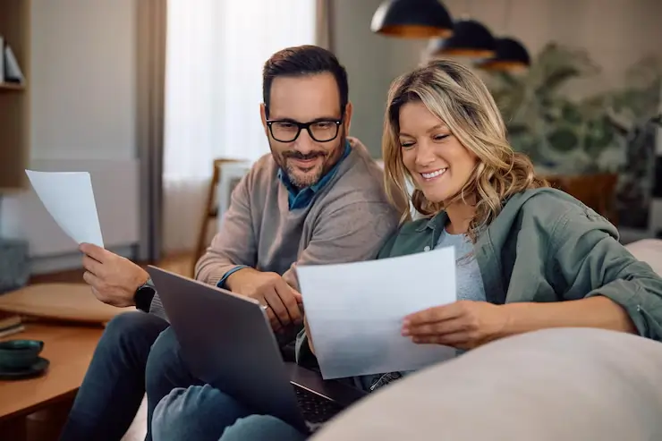 Homeowner happily reviewing an electric bill